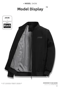 Detail view of black corduroy jacket with leather logo patch and striped inner lining