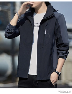 Detail of waterproof windbreaker featuring gray contrast stitching and sport zipper pocket