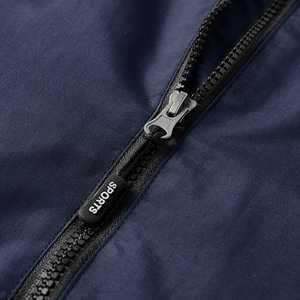 Men's waterproof jacket closeup showing zipper detail and durable deep blue fabric