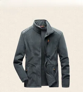 Detail of dark gray fleece jacket featuring orange zipper accents and a stand collar