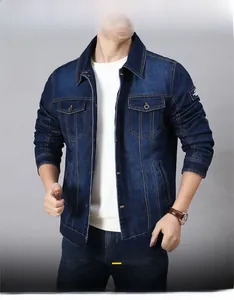 Detail of dark blue denim jacket with flap chest pockets and metallic hardware buttons