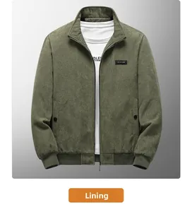 Detail of dark green corduroy jacket showing zipper, ribbed hem, and chest logo patch