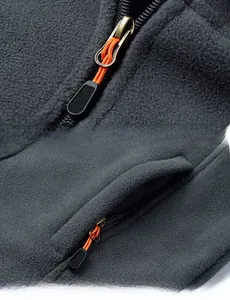 Detail of fleece jacket with vintage gold zipper and orange cord toggle on stand collar