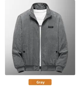 Detailed close-up of dark grey corduroy jacket texture and logo patch on chest