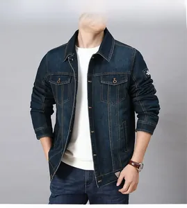 Detail view of men's dark blue denim jacket with flap pockets and bronze buttons