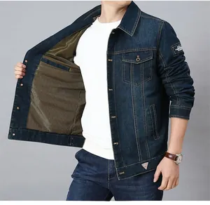 Detail of dark blue denim jacket with gold honeycomb mesh lining and embroidered patch
