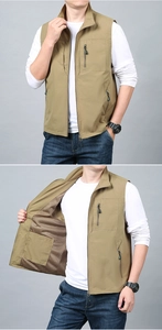 Detail of khaki outdoor vest showing mesh breathable lining and functional zipper pockets
