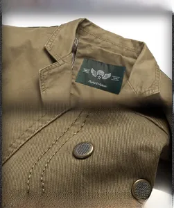 Detail view of men's cotton jacket showing stand-up collar and metal mesh underarm vents