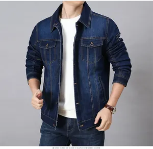 Detail of dark blue denim jacket featuring classic washed texture and cargo chest pockets