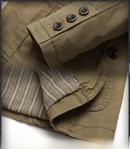 Detail view of khaki cotton jacket showing buttoned cuffs and striped lining finish