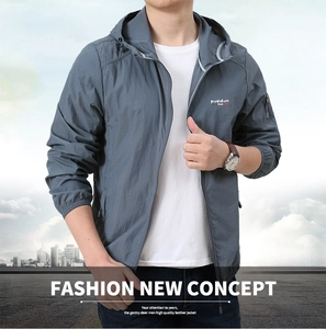 Detail of gray lightweight sun protection jacket with hood and zip-up chest branding
