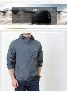 Detail of blue-grey sun protection jacket showing zipper pocket and chest logo print