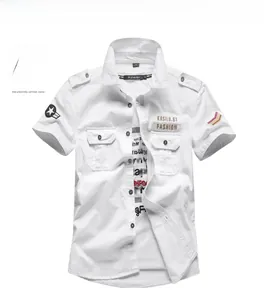 Detail of white military style short sleeve shirt with embroidered patches and epaulettes