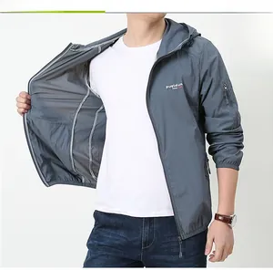 Detail view of breathable inner lining and logo on gray men's hooded sun protection jacket