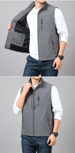 Detail of grey outdoor vest showing front zip pockets and internal storage structure