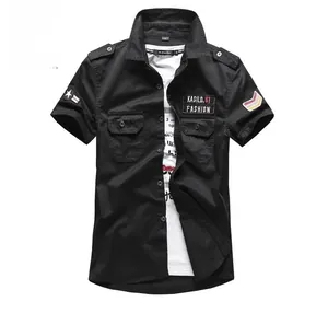 Detail of black military work shirt with chest pockets and fashion embroidery patches