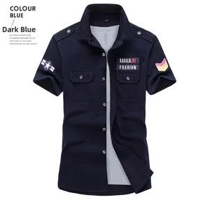 Detail of dark blue military style shirt with embroidered patches and shoulder straps