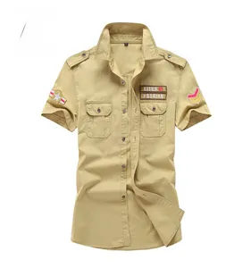 Close-up of khaki military short sleeve shirt featuring shoulder straps and dual chest pockets