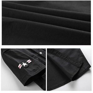 Detailed macro view of black military shirt fabric texture and star embroidery