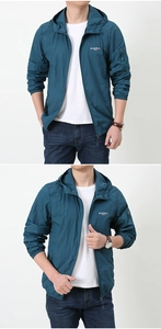 Detail view of men's blue sun protection jacket with hood and chest logo embroidery