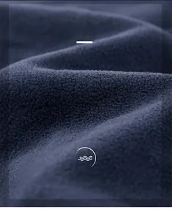 Detailed macro view of dark blue polar fleece fabric texture showing warmth and softness