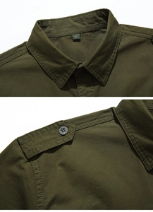 Close-up of olive green military shirt showing collar size label and engraved shoulder button