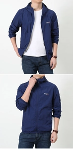 Detail of dark blue hooded windbreaker jacket with zipper and Puqidun logo