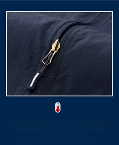 Detailed close-up of smooth metal zipper with reflective puller on outdoor vest