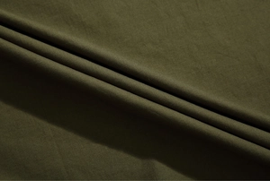 Close-up of military green cotton fabric texture and weave for short sleeve cargo shirts