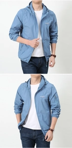 Detail view of light blue sun protection jacket with hood drawstring and arm pocket