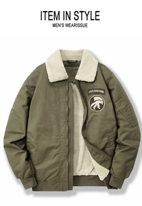 Detail of olive green bomber jacket featuring white sherpa lining and army airborne patches