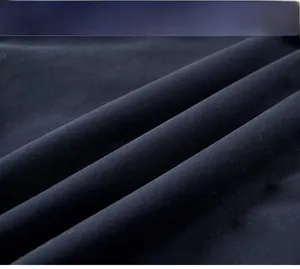 Macro shot of durable navy blue twill fabric showing tight weave texture and soft folds