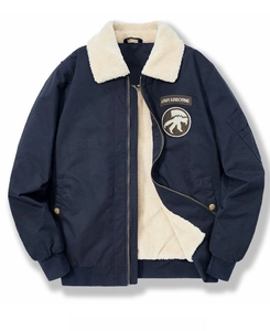 Detail of navy blue pilot jacket showing white sherpa fleece collar and Army Airborne patches