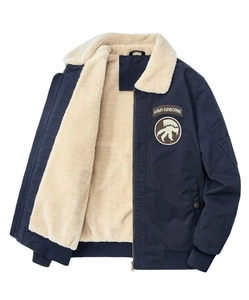 Detail of navy blue pilot jacket showing thick sherpa lining and army airborne patch