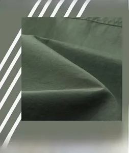 Detail of dark green heavy twill fabric showing high-quality texture and firm material