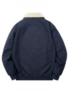 Detail of navy workwear jacket featuring thick white faux lamb wool collar and ribbed hem