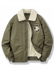 Detail of army airborne embroidery and lamb wool collar on green bomber jacket