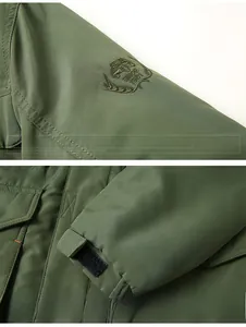 Detail of army green jacket featuring embroidered sleeve patch and adjustable velcro cuffs