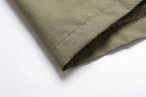 Detail of army green outdoor vest showing breathable mesh lining and fine stitching quality