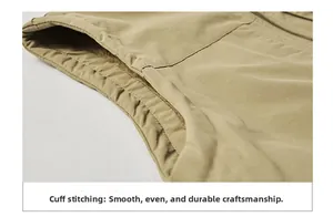 Vue détaillée de l'emmanchure du gilet kaki montrant des coutures plates et renforcées