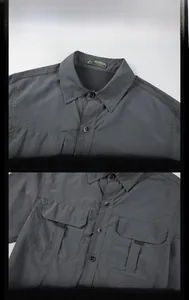 Detailed view of dark grey outdoor shirt featuring chest pockets and durable stitching