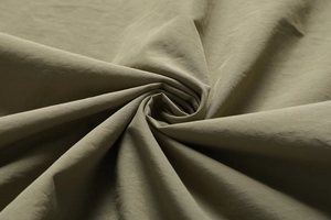 Detailed macro view of olive green twill fabric texture for outdoor utility vest