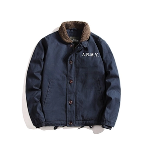 Detail of navy blue winter jacket featuring faux fur collar and A.R.M.Y. print on chest