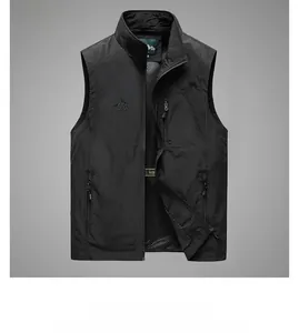 Detail of black outdoor vest showing durable ripstop nylon fabric and mountain embroidery