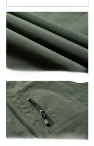 Detail of army green outdoor vest featuring secure zipper pocket and reinforced stitching