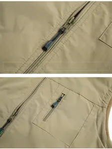 Close-up of premium metal zipper detail with SPORTS puller on khaki outdoor vest