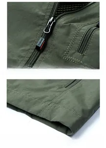 Detail of army green outdoor vest showing zip pocket with sports puller and stitching