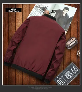 Back view of a burgundy bomber jacket with black ribbed trims on vintage wood background