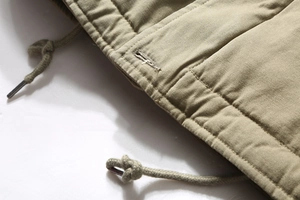 Macro view of khaki heavy cotton jacket with thick drawstring and reinforced eyelets