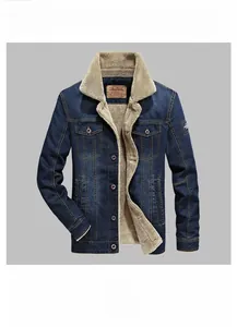 Detail of dark blue denim jacket with thick beige fleece lining and buttoned pockets